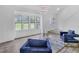 Bright living room with large windows, wood-look flooring, and stylish modern seating at 3706 Londonderry Ct, Lithonia, GA 30038
