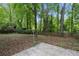 Backyard with concrete patio, tree coverage and a wood fence at 856 Bridgewater Sw St, Atlanta, GA 30310