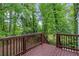View from the wooden deck surrounded by lush green trees at 856 Bridgewater Sw St, Atlanta, GA 30310
