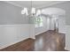 Dining area with hardwood floors and modern chandelier with view to kitchen and living room at 856 Bridgewater Sw St, Atlanta, GA 30310