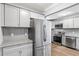 Modern kitchen with stainless steel appliances, gray cabinets, granite countertops and tile backsplash at 856 Bridgewater Sw St, Atlanta, GA 30310
