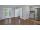 View of stainless steel refrigerator, and access to a covered porch and hardwood floors at 856 Bridgewater Sw St, Atlanta, GA 30310