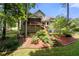 Home's backyard features a screened porch, stairs down to the yard, and mature trees along the fence line at 2214 Trilleck Nw Dr, Kennesaw, GA 30152
