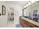Bathroom with granite counter and vanity with double mirrors and an open doorway to a toilet and shower at 2214 Trilleck Nw Dr, Kennesaw, GA 30152
