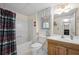 Bright bathroom featuring a tub-shower combination and wooden vanity with solid surface counter at 2214 Trilleck Nw Dr, Kennesaw, GA 30152