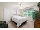 Comfortable bedroom with large window offering a serene view of the outdoors at 2214 Trilleck Nw Dr, Kennesaw, GA 30152