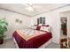 Well-lit bedroom with a red and floral comforter on the bed and floral wallpaper trim at 2214 Trilleck Nw Dr, Kennesaw, GA 30152