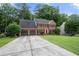 Beautiful brick home features a manicured front yard and attached two-car garage at 2214 Trilleck Nw Dr, Kennesaw, GA 30152