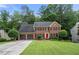 Traditional brick home with a well-manicured lawn and two-car garage at 2214 Trilleck Nw Dr, Kennesaw, GA 30152