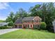 Charming two-story brick home featuring an attached two-car garage and a well-manicured lawn at 2214 Trilleck Nw Dr, Kennesaw, GA 30152