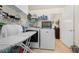 Functional laundry room with washer, dryer, and ample storage space at 2214 Trilleck Nw Dr, Kennesaw, GA 30152