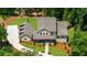 Expansive aerial view of a two-story home with a manicured lawn and a long driveway at 313 Anderwood Rdg, Marietta, GA 30064