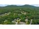 Aerial view of a beautiful community surrounded by dense woods and rolling hills at 313 Anderwood Rdg, Marietta, GA 30064
