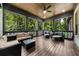 Relaxing screened-in porch with comfortable seating, offering a serene outdoor living experience with wooded views at 313 Anderwood Rdg, Marietta, GA 30064