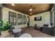 Inviting covered back porch with brick wall, offering a relaxing outdoor living space with wooded views at 313 Anderwood Rdg, Marietta, GA 30064