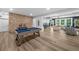 Finished basement boasts a brick accent wall, pool table, and spacious seating area at 313 Anderwood Rdg, Marietta, GA 30064