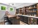 Finished basement bar features open shelving, cabinets, and a mini-fridge for storing beverages at 313 Anderwood Rdg, Marietta, GA 30064