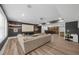 Open basement area with a large sectional sofa, media screen, bar, and ample space for entertainment at 313 Anderwood Rdg, Marietta, GA 30064