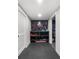 Basement storage area with a wall-mounted shelving unit to store gym equipment and accessories at 313 Anderwood Rdg, Marietta, GA 30064