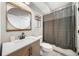 Cozy bathroom featuring a wooden vanity, round mirror, shower with curtain, and stylish shelving at 313 Anderwood Rdg, Marietta, GA 30064