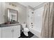 Stylish bathroom featuring a tiled shower and floor, vanity, and mirror at 313 Anderwood Rdg, Marietta, GA 30064