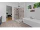 Primary bathroom featuring a soaking tub, glass shower, and a view into the main bedroom at 313 Anderwood Rdg, Marietta, GA 30064