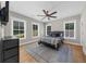 Cozy bedroom featuring a ceiling fan, natural light, and hardwood floors at 313 Anderwood Rdg, Marietta, GA 30064