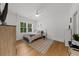 Bright bedroom with hardwood floors, ceiling fan, and large window offering ample natural light and outdoor views at 313 Anderwood Rdg, Marietta, GA 30064
