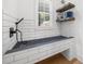 Convenient dog wash station with subway tile surround, handheld sprayer, and custom bench for easy pet care at 313 Anderwood Rdg, Marietta, GA 30064