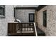 Private outdoor space featuring a wooden deck, a grill, and brick walls at 313 Anderwood Rdg, Marietta, GA 30064