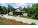 Charming two-story home with a brick driveway surrounded by lush greenery at 313 Anderwood Rdg, Marietta, GA 30064