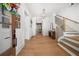 Bright entryway with wood floors, a staircase with black wrought iron spindles, and a statement light fixture at 313 Anderwood Rdg, Marietta, GA 30064