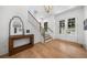 Bright foyer featuring wood floors, stairs with black wrought iron spindles, and french doors to the exterior at 313 Anderwood Rdg, Marietta, GA 30064