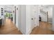 Open concept: View from entry to kitchen, hallway, and stairs, featuring wood floors and a modern style at 313 Anderwood Rdg, Marietta, GA 30064
