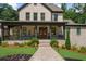 Close up of the home's charming front porch, featuring seasonal wreaths and a brick walkway at 313 Anderwood Rdg, Marietta, GA 30064