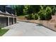 View of the three-car garage with a large driveway and professional retaining wall at 313 Anderwood Rdg, Marietta, GA 30064