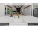 A modern kitchen featuring white countertops, a farmhouse sink and views into the living room at 313 Anderwood Rdg, Marietta, GA 30064