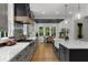 A modern kitchen with gray cabinets, stainless steel appliances, and dining room in the background at 313 Anderwood Rdg, Marietta, GA 30064