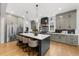 A spacious kitchen features a large island with seating, stainless steel appliances and custom cabinets at 313 Anderwood Rdg, Marietta, GA 30064