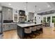 A spacious open-concept kitchen featuring a large island with bar seating and a dining room in the background at 313 Anderwood Rdg, Marietta, GA 30064