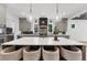 A modern kitchen with gray cabinets, stainless steel appliances, an island with bar seating and pendant lighting at 313 Anderwood Rdg, Marietta, GA 30064