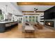 Spacious open-concept living room with wood floors, a stone fireplace, and views of the gourmet kitchen at 313 Anderwood Rdg, Marietta, GA 30064