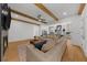 Spacious living room with fireplace and wooden beams seamlessly transitions into the modern kitchen for open-concept living at 313 Anderwood Rdg, Marietta, GA 30064