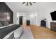 Main bedroom features a ceiling fan, light wood floors, and view into the bathroom and closet at 313 Anderwood Rdg, Marietta, GA 30064