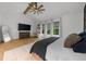 The main bedroom features a ceiling fan, light wood floors, and a sunny view from the windows at 313 Anderwood Rdg, Marietta, GA 30064