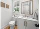 Stylish powder room with decorative mirror, modern vanity, and chic fixtures offering a touch of elegance at 313 Anderwood Rdg, Marietta, GA 30064