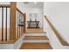Elegant staircase featuring wood steps, wooden handrail, and black metal spindles at 313 Anderwood Rdg, Marietta, GA 30064