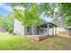 Green backyard featuring a well-maintained lawn, mature trees, brick patio and large porch at 4959 Abbotts Glen, Acworth, GA 30101