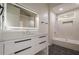 Bright bathroom featuring a modern vanity, sleek fixtures, and a shower-tub combo with neutral tile at 4959 Abbotts Glen, Acworth, GA 30101