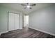 This bedroom features a ceiling fan, closet, hardwood floors, and neutral-colored walls at 4959 Abbotts Glen, Acworth, GA 30101